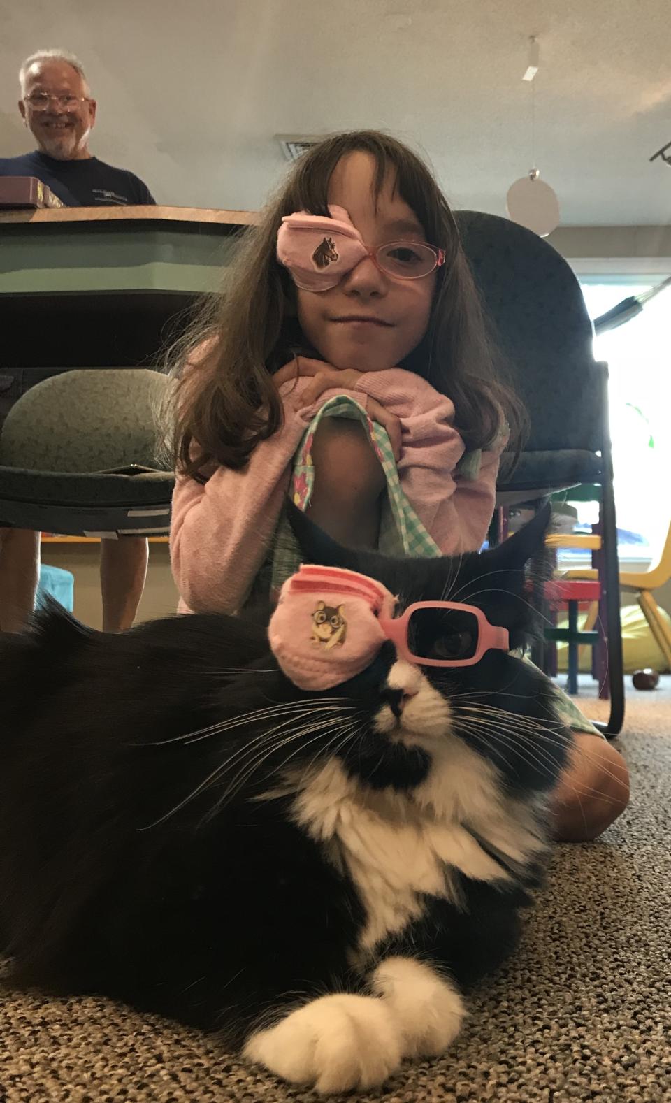 Truffles and a young girl wear eye patches. (Courtesy of A Child's Eyes)