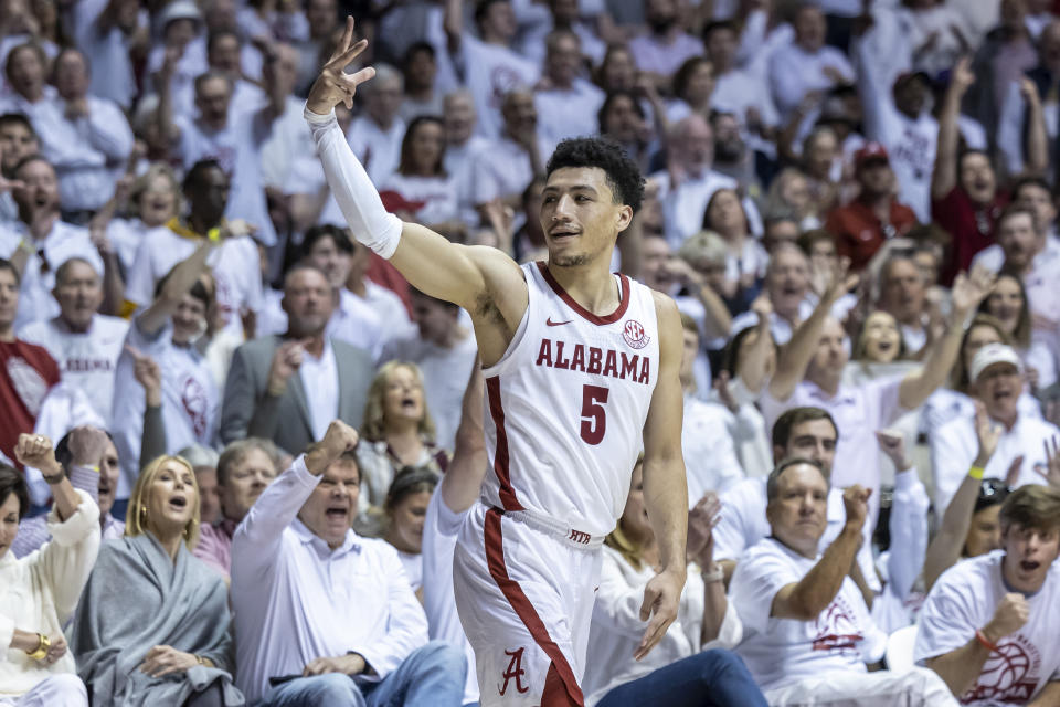 Alabama guard Jahvon Quinerly (5) signals a 3-pointer after his shot fell during the second half of an NCAA college basketball game against Arkansas, Saturday, Feb. 25, 2023, in Tuscaloosa, Ala. (AP Photo/Vasha Hunt)