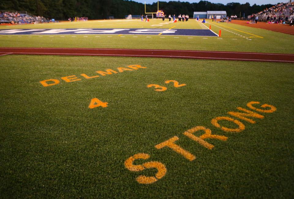 The Lake Forest football field is stenciled with a message of support for Delmar and two players involved in last week's tragic car accident - Carter Powell (4) who was badly hurt and Carter Figgs (32), who lost his life - as the two teams meet at Lake Forest High School, Thursday, Oct. 12, 2023.