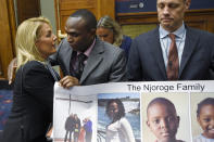 Sara Nelson, left, President of the Association of Flight Attendants, hugs Paul Njoroge, center, before the start of a House Transportation subcommittee hearing on Capitol Hill in Washington, Wednesday, July 17, 2019, on aviation safety as Michael Stumo, right, helps to hold a poster. Njoroge lost his wife and three young children on Ethiopian Airlines Flight 302 and Stumo lost his daughter on the same flight. The plane was a Boeing 737 MAX. (AP Photo/Susan Walsh)