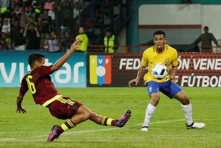 Football Soccer - Venezuela v Brazil - World Cup 2018 Qualifiers - Metropolitano Stadium, Merida, Venezuela - 11/10/16 - Brazil's Gabriel Jesus (R) and Venezuela's Roberto Rosales in action. REUTERS/Marco Bello