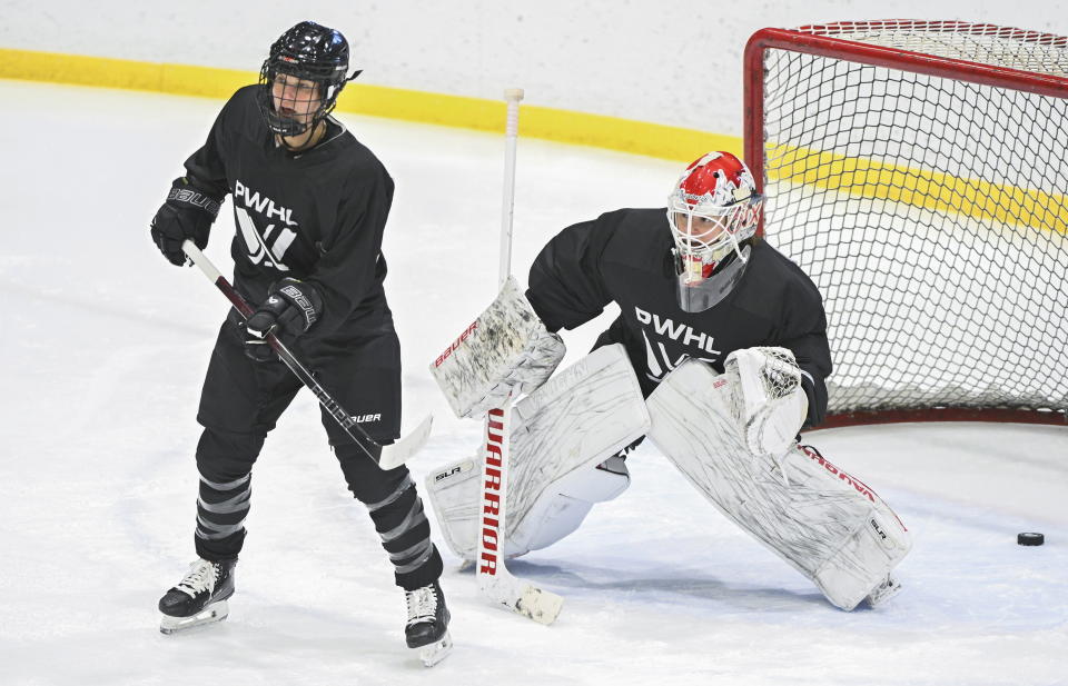 Montreal's Marie-Philip Poulin, left, screens goaltender Elaine Chuli during Professional Women's Hockey League (PWHL) training camp in Montreal, Saturday, Nov. 18, 2023. (Graham Hughes/The Canadian Press via AP)