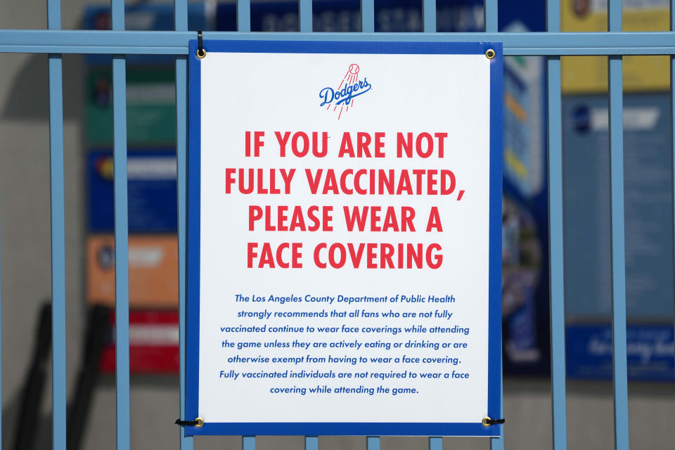 Jul 10, 2021; Los Angeles, California, USA; A COVID-19 coronavirus face mask advisory is seen at Dodger Stadium before a game between the Arizona Diamondbacks and the Los Angeles Dodgers. Mandatory Credit: Kirby Lee-USA TODAY Sports