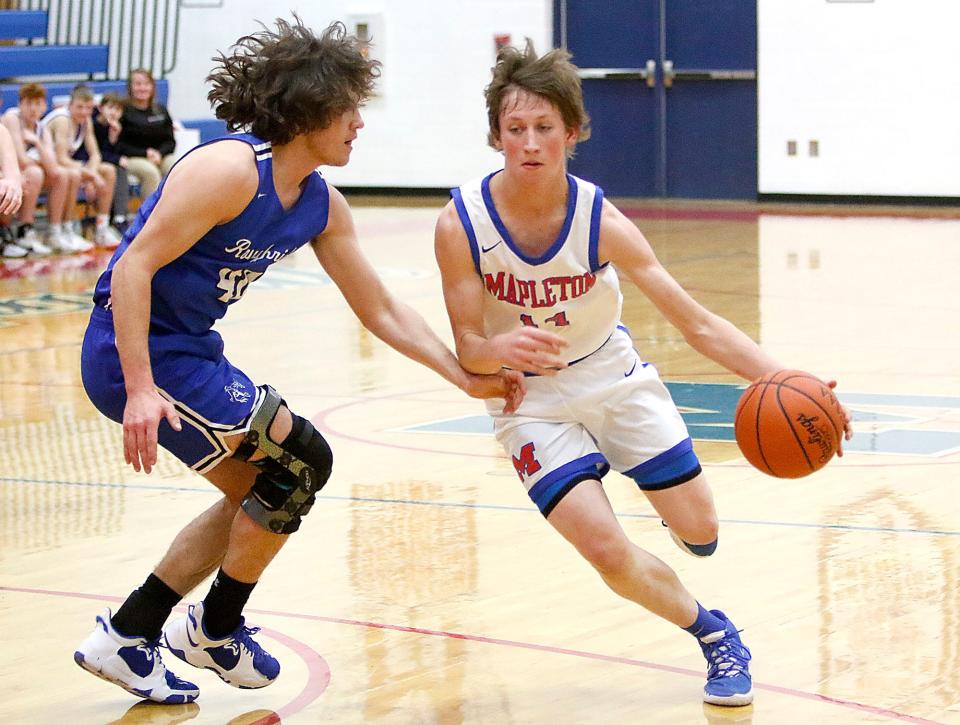 Mapleton High School's Jed Brannon (14) drives with the ball against Western Reserve High School's Carson Roe during high school boys basketball action Thursday, Jan. 13, 2022 at Mapleton High School. TOM E. PUSKAR/TIMES-GAZETTE.COM