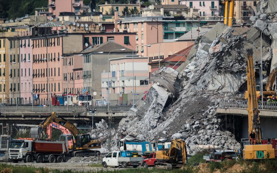 Diggers work through the wreckage of the Morandi Bridge days after a section of it collapsed - Getty Images Europe