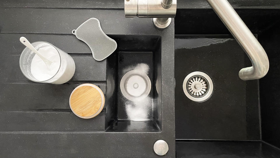 black sink with shining clean plugholes