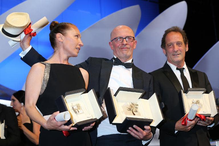 French actress Emmanuelle Bercot (L), French director Jacques Audiard (C) and French actor Vincent Lindon pose on stage after their prizes at the closing Cannes Film Festival ceremony