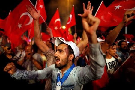 Supporters of Turkish President Tayyip Erdogan wave Turkish flags during a pro-government demonstration at Taksim square in central Istanbul, Turkey, July 20, 2016. REUTERS/Ammar Awad