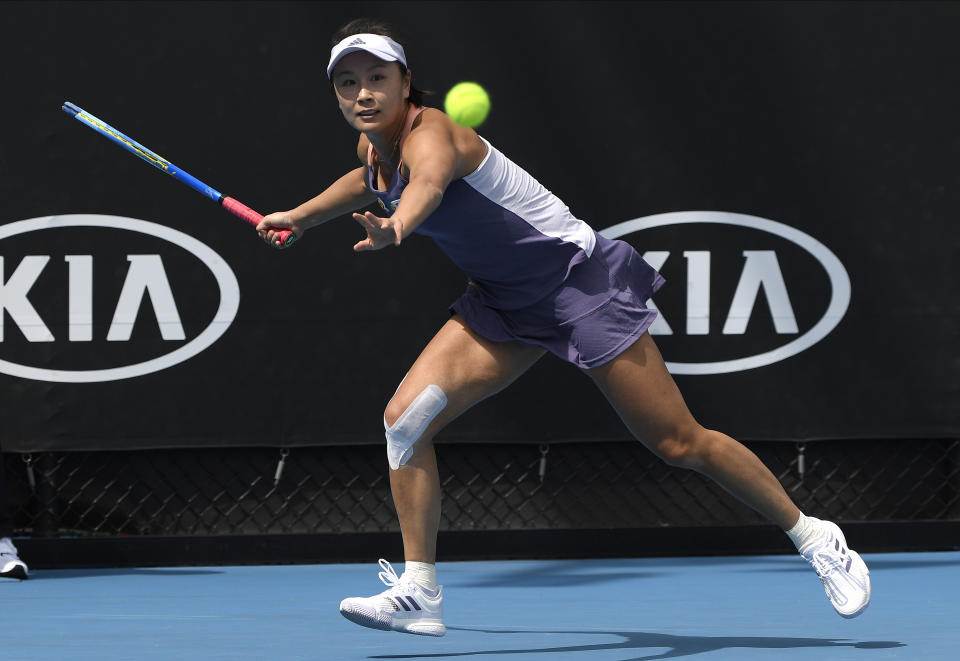 FILE - China's Peng Shuai makes a forehand return to Japan's Nao Hibino during their first round singles match at the Australian Open tennis championship in Melbourne, Australia, Tuesday, Jan. 21, 2020. The head of the women’s professional tennis tour announced Wednesday, Dec. 1, 2021, that all WTA tournaments would be suspended in China because of concerns about the safety of Peng Shuai, a Grand Slam doubles champion who accused a former high-ranking government official in that country of sexual assault. (AP Photo/Andy Brownbill, File)