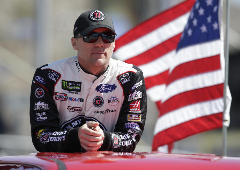 Kevin Harvick (4) stands during a parade lap before a NASCAR Cup Series auto race on Sunday, March 11, 2018, in Avondale, Ariz. (AP Photo/Rick Scuteri)