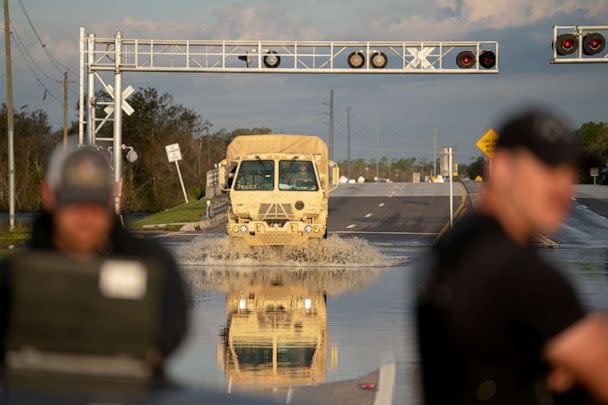 PHOTO: A National Guard vehicle drives through floodwaters from the Peace River on October 4, 2022 in Arcadia, Florida.  (Sean Rayford/Getty Images)