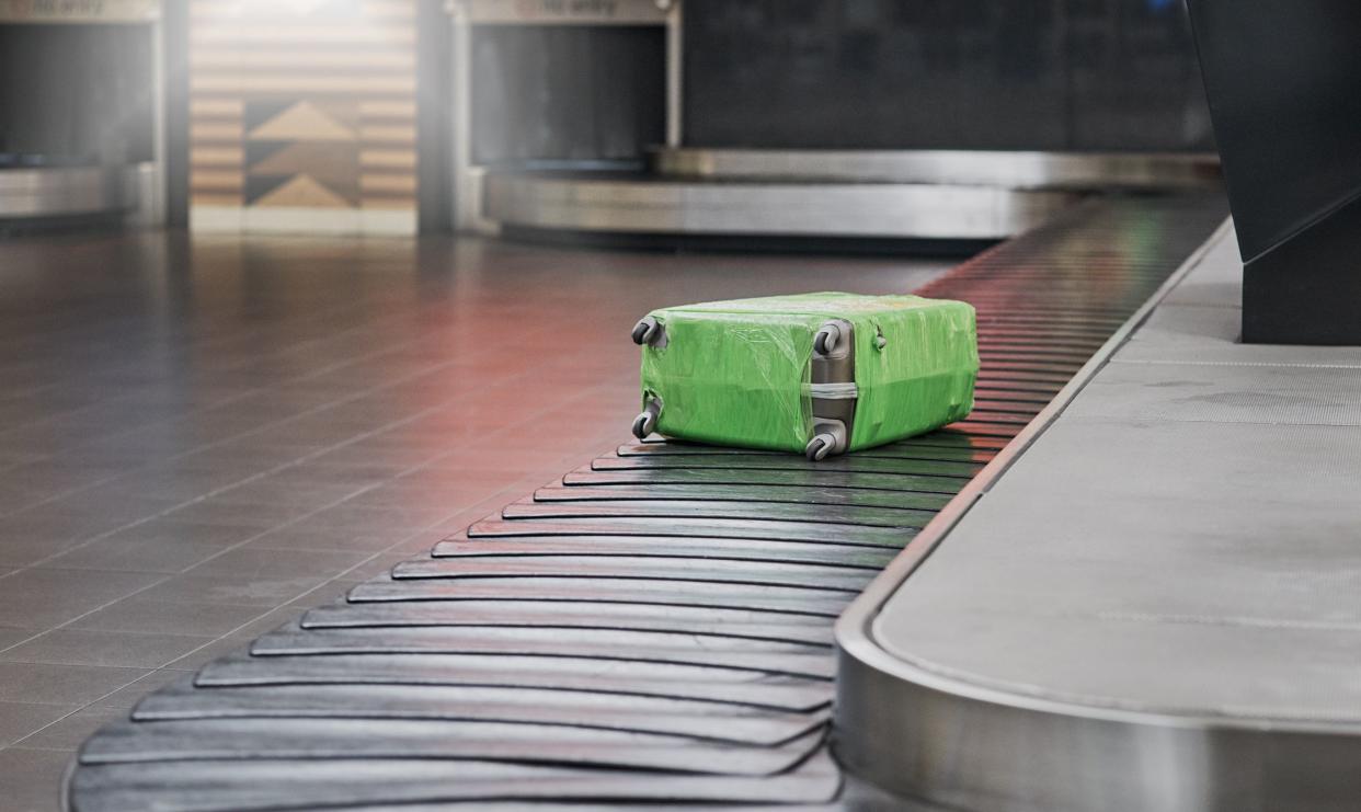 Shot of a suitcase in an airport’s baggage claim area