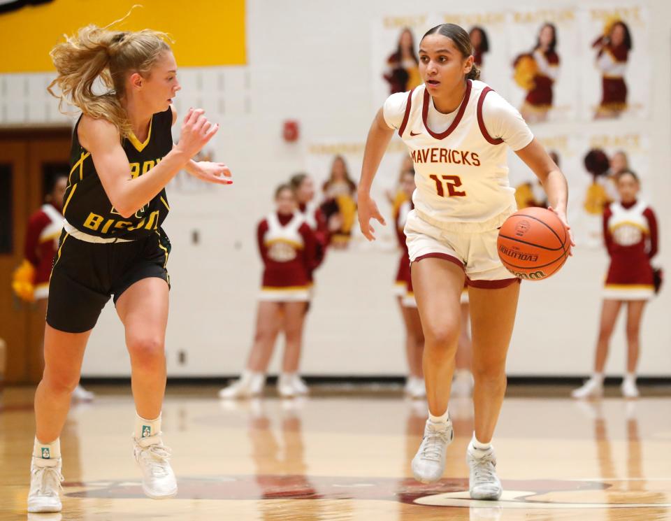 Benton Central Bison Sienna Foster (23) defends McCutcheon Mavericks Lillie Graves (12) during the IHSAA girl’s basketball game, Thursday, Jan. 4, 2024, at McCutcheon High School in Lafayette, Ind. McCutcheon won 37-36.