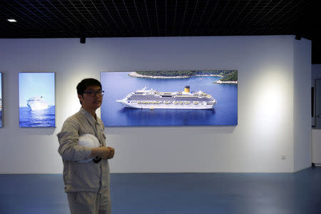 An employee stands at a showroom of Shanghai Waigaoqiao Shipbuilding Co., Ltd. in Shanghai, China June 15, 2017. Picture taken June 15, 2017. REUTERS/Aly Song