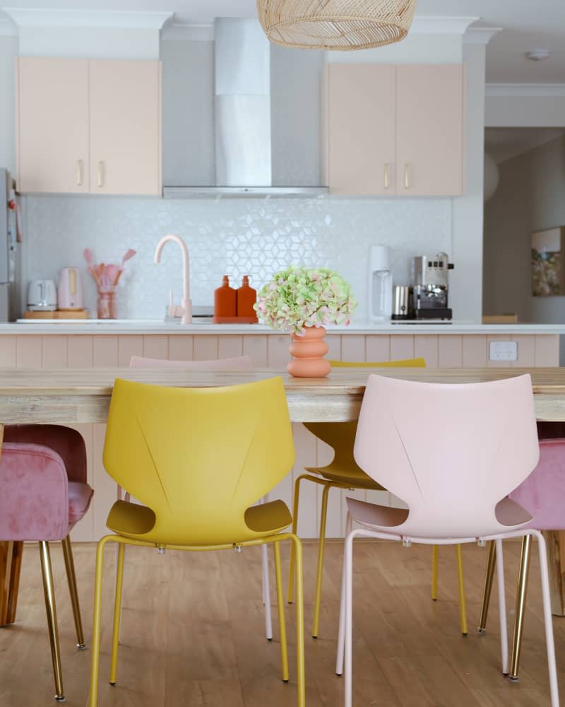 view into white tile and pale peach kitchen from dining area