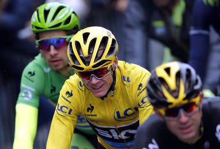 Team Sky rider Chris Froome of Britain, the race leader's yellow jersey, reacts as he cycles on the Champs-Elysees avenue during the109.5-km (68 miles) final 21st stage of the 102nd Tour de France cycling race from Sevres to Paris Champs-Elysees, France, July 26, 2015. REUTERS/Stephane Mahe