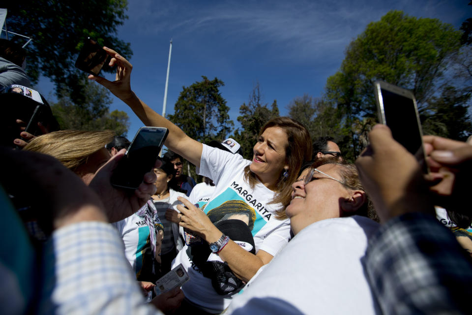 FILE - Former first lady Margarita Zavala poses for a photo with a supporter during a rally to collect signatures to qualify as an independent candidate for the upcoming presidential race, in Mexico City, Feb. 11, 2018. (AP Photo/Eduardo Verdugo, File)