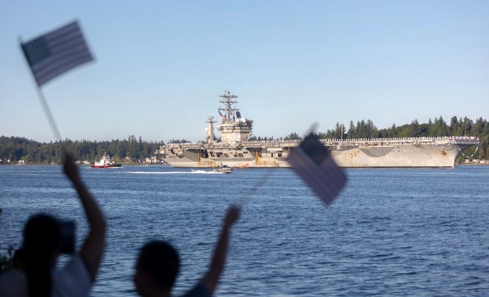Onlookers at Bachmann Park in Bremerton watch as the USS Nimitz arrives back in Bremerton on Sunday, July 2, after a seven-month deployment.