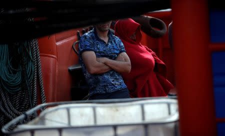 FILE PHOTO: Migrants intercepted aboard a dinghy off the coast in the Strait of Gibraltar, are seen on a rescue boat after arriving at the Port of Algeciras, southern Spain, June 30, 2018. REUTERS/Jon Nazca/File Photo