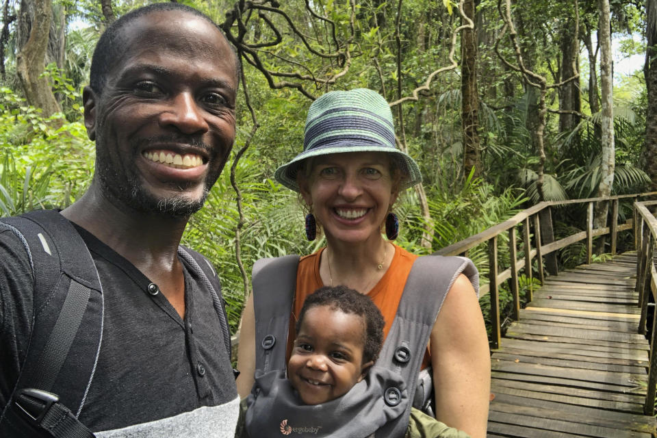 This Sept. 13, 2019 photo provided by the family shows Adebambo Alli, left, Robin Gallite and their adopted daughter, Adenike-Rae, at the Lekki Conservation Center, a natural reserve protecting the wetlands of the Lekki peninsula in Nigeria. Stranded in Nigeria for months, the couple had a rare chance to board a U.S-bound evacuation flight amid the coronavirus outbreak. They refused to fly because Adenike-Rae has yet to receive a U.S. visa and they would have had to leave her behind. (Adebambo Alli via AP)