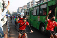 Bikers flash the three-fingered salute in Yangon, Myanmar on Sunday, Feb. 7, 2021. Thousands of people rallied against the military takeover in Myanmar's biggest city on Sunday and demanded the release of Aung San Suu Kyi, whose elected government was toppled by the army that also imposed an internet blackout. (AP Photo)