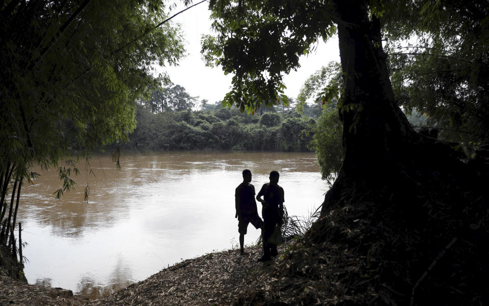 Prince Tete and his friend Coudjoe stand at a point where it is believed slaves once crossed the River Pra on their journey to the coast, at Assin Praso, Ghana. (Photo: Siphiwe Sibeko/Reuters)