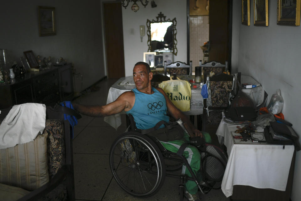 Manuel Mendoza deja su raqueta de tenis y sus herramientas después del entrenamiento, en su casa en el barrio La Paz de Caracas, Venezuela, el sábado 14 de noviembre de 2020. (AP Foto/Matias Delacroix)