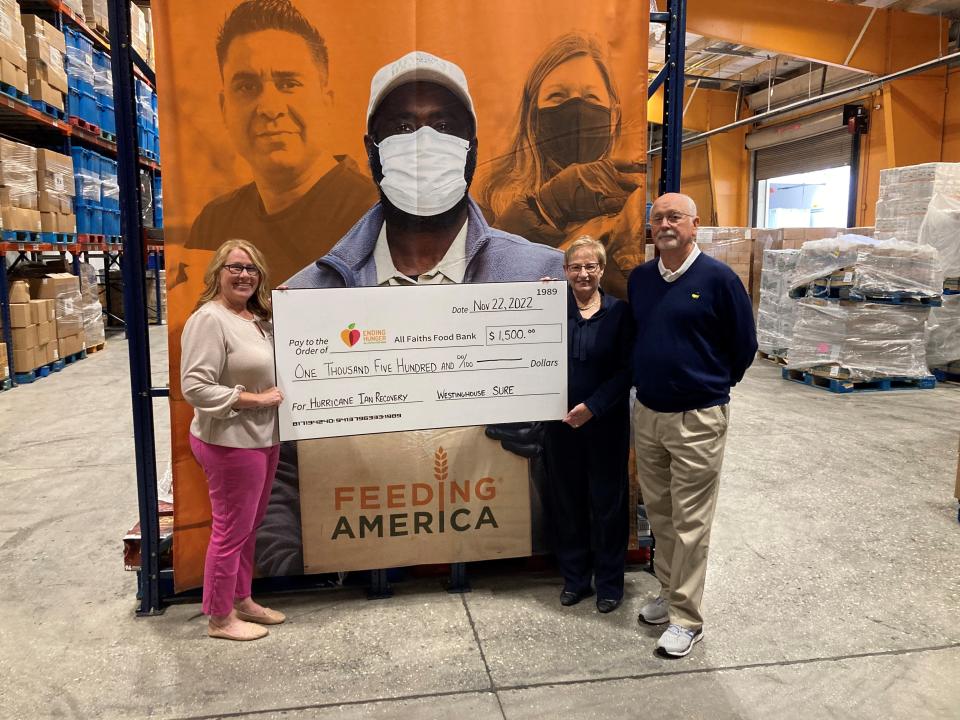 Joe Tain and Pat Loftus, of SURE’s newly formed Florida Chapter, presented the group's donation to All Faiths Food Bank. Accepting the check is Rachel Bradley, left, director of philanthropy.