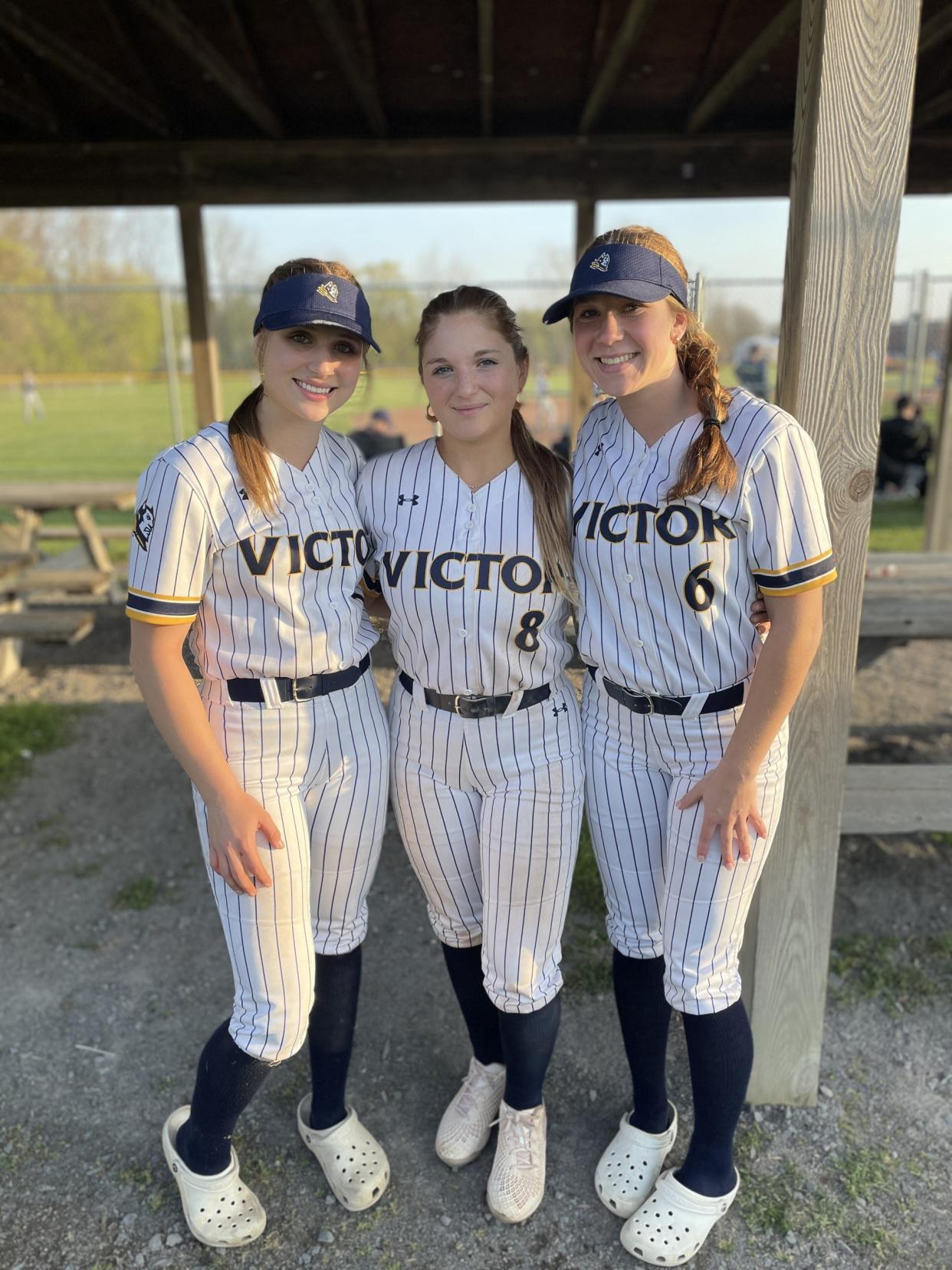 Victor softball players Olivia Steinorth, left, Audrey Steinorth, middle, and Kennedy Chizuk after a game against Bloomfield Monday, April 29, 2024 in Victor.