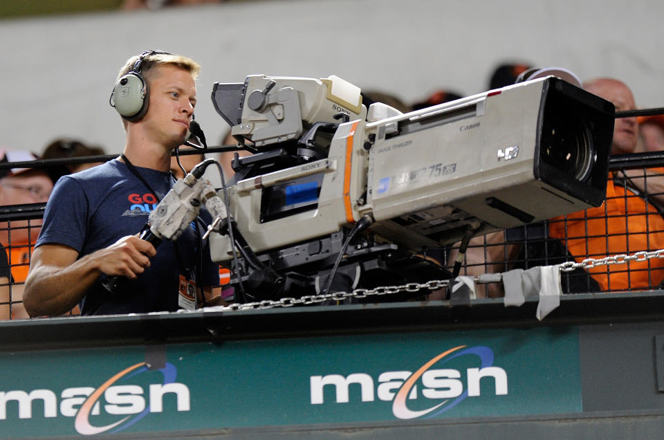 BALTIMORE, MD - AUGUST 04:  Geoff Britten works the camera during an MLB game between the Baltimore Orioles and the Texas Rangers at Oriole Park at Camden Yards on August 4, 2016 in Baltimore, Maryland.  (Photo by G Fiume/Getty Images)