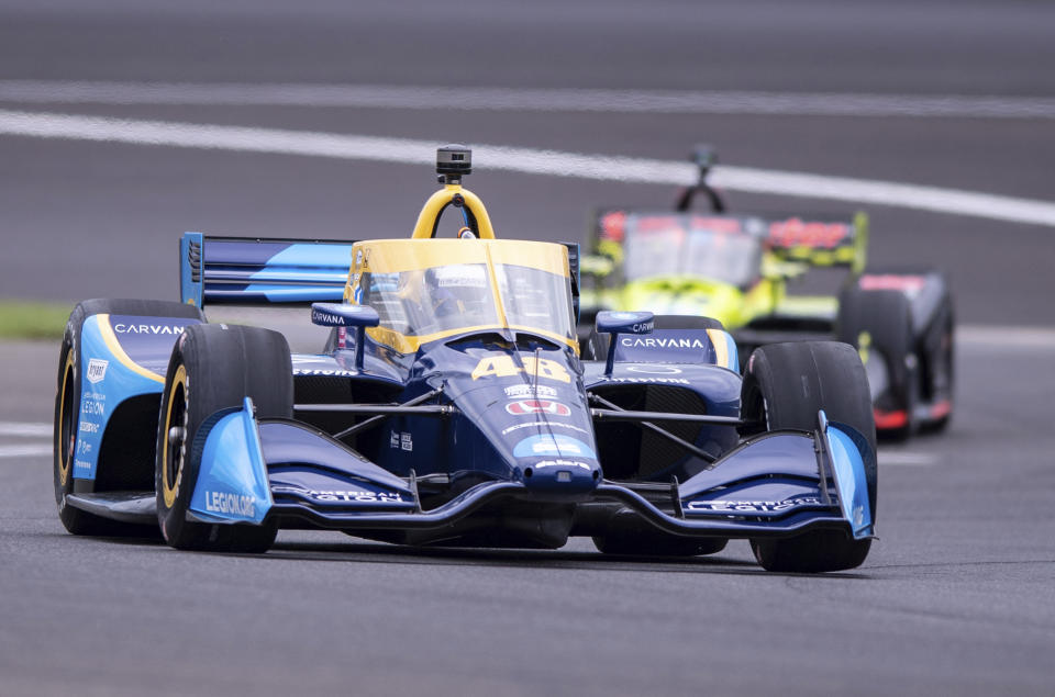 Jimmie Johnson drives along the course during a practice session for the IndyCar auto race at Indianapolis Motor Speedway, Friday, Aug. 13, 2021, in Indianapolis. (AP Photo/Doug McSchooler)