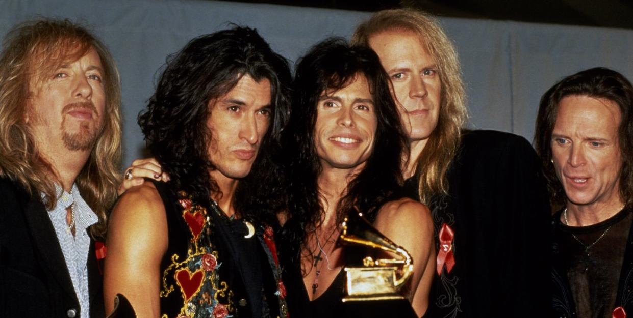 brad whitford, joe perry, steven tyler, tom hamilton, and joey kramer of aerosmith at the 36th annual grammy awards, whitford and tyler each hold one grammy award