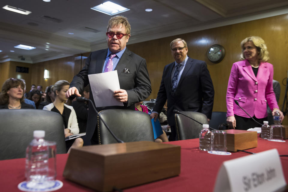 FILE - In this May 6, 2015, file photo, musician Sir Elton John, followed by Rev. Rick Warren and Ambassador at Large and Coordinator of the U.S. Government Activities to Combat HIV/AIDS, Dr. Deborah L. Birx, arrives on Capitol Hill in Washington. Birx was brought into President Donald Trump’s orbit to help fight the coronavirus, she had a sterling reputation as a globally recognized AIDS researcher and a rare Obama administration holdover. Less than 10 months later, her reputation is frayed and her future in President-elect Joe Biden's administration uncertain. (AP Photo/Brett Carlsen, File)