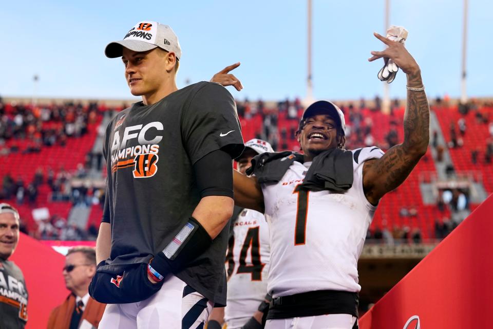 Cincinnati Bengals quarterback Joe Burrow, left, and wide receiver Ja'Marr Chase (1) celebrate after the AFC championship NFL football game against the Kansas City Chiefs, Sunday, Jan. 30, 2022, in Kansas City, Mo. The Bengals won 27-24 in overtime.