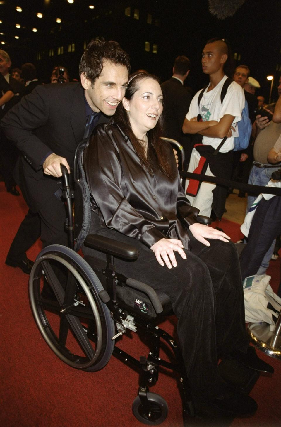 Ben Stiller helps producer Jenifer Estess, a 2001 Woman of the Year, at a 1999 event that raised $1.5 million for her Project ALS.
