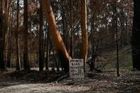 A sign warning potential trespassers to turn around is pictured at the front of a property burnt during the recent bushfires near Batemans Bay