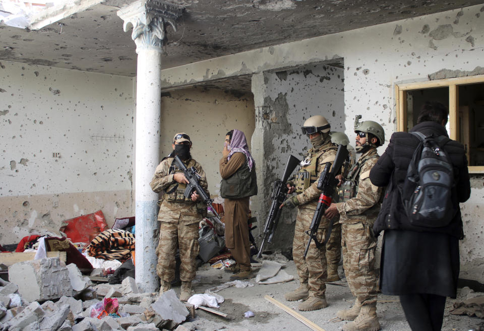 Taliban fighters inspect a house after an 8-hour gunbattle erupted between Taliban and Islamic State group fighters, when Taliban forces raided a suspected hideout of IS militants on the outskirts of Jalalabad, east of Kabul, Afghanistan, Tuesday, Nov. 30, 2021. Taliban fighters have summarily killed or forcibly “disappeared” more than 100 former police and intelligence officers since taking power in Afghanistan, Human Rights Watch said in a report Tuesday. (AP Photo/Shir Shah Hamdard)