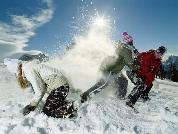 Three kids playing in the snow