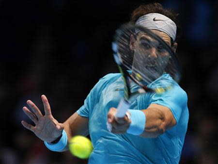 Rafael Nadal of Spain hits a return during his men's singles tennis match against Stanislas Wawrinka of Switzerland at the ATP World Tour Finals at the O2 Arena in London November 6, 2013. REUTERS/Suzanne Plunkett