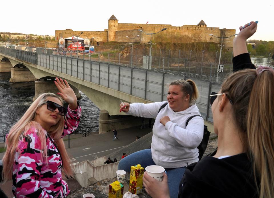 People watch a Victory Day concert from across the river in Narva, Estonia (Reuters)