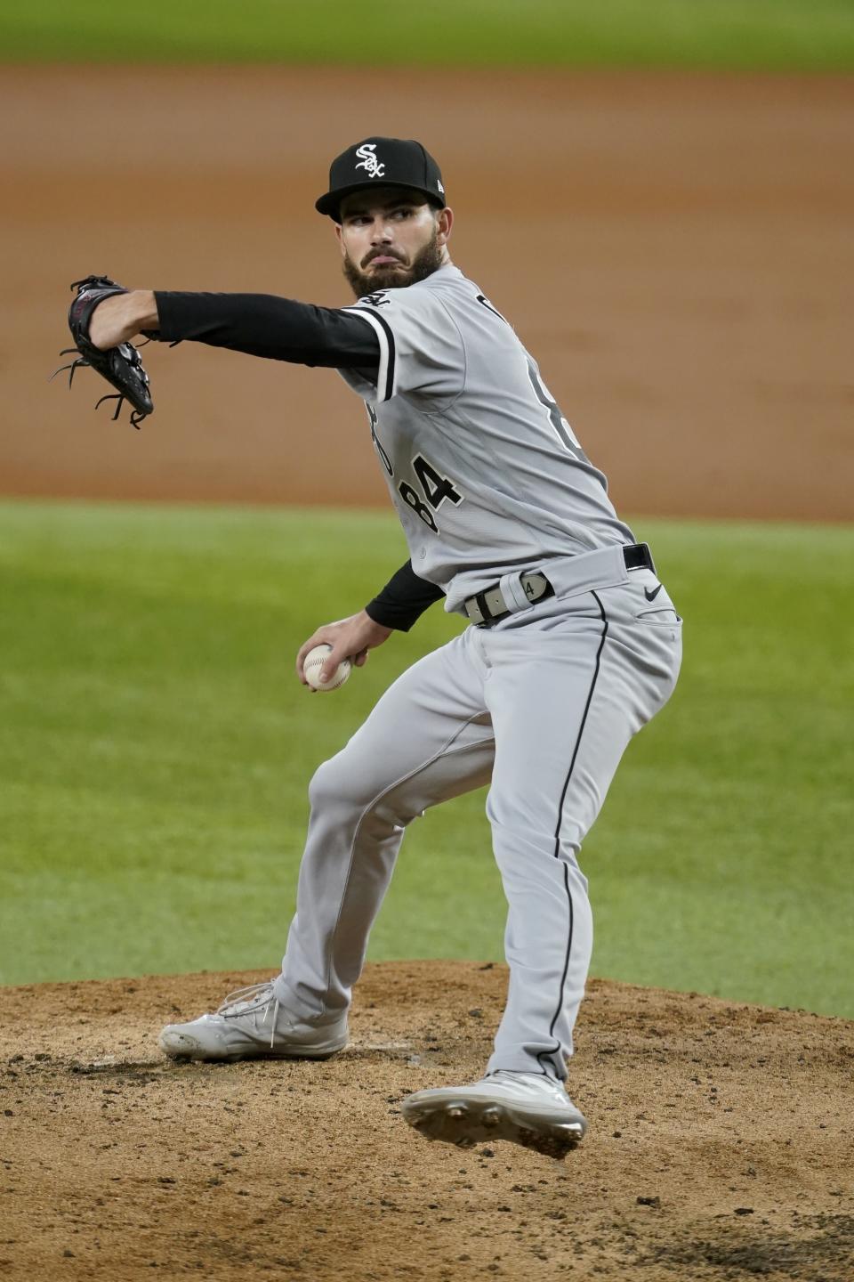 Chicago White Sox starting pitcher Dylan Cease winds up to throw to a Texas Rangers batter during the second inning of a baseball game in Arlington, Texas, Friday, Sept. 17, 2021. (AP Photo/Tony Gutierrez)