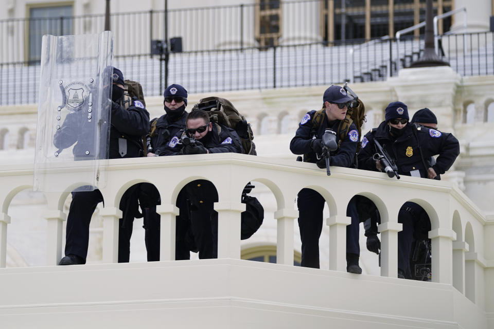 FILE - In this Jan. 6, 2021, file photo, police keep a watch on demonstrators who tried to break through a police barrier at the Capitol in Washington. A blistering internal report by the U.S. Capitol Police describes a multitude of missteps that left the force unprepared for the Jan. 6 insurrection — riot shields that shattered upon impact, expired weapons that couldn’t be used, inadequate training and an intelligence division that had few set standards. (AP Photo/Julio Cortez, File)