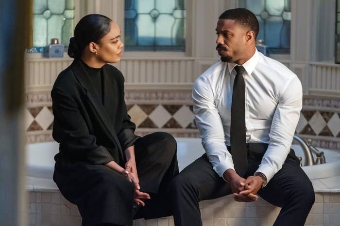 From left to right, Tessa and Michael sit on the edge of a bathroom tub in a scene from the film