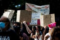 People rally for the defunding of police and reinvestment in community before marching to Seattle Mayor Durkan's home in Seattle