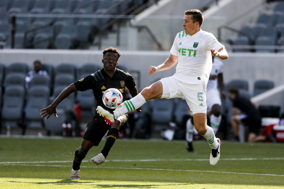 Austin FC defender Matt Besler (5) controls the ball next to Los Angeles FC forward Kwadeo Opoku during the second half of an MLS soccer match Saturday, April 17, 2021, in Los Angeles. (AP Photo/Ringo H.W. Chiu)