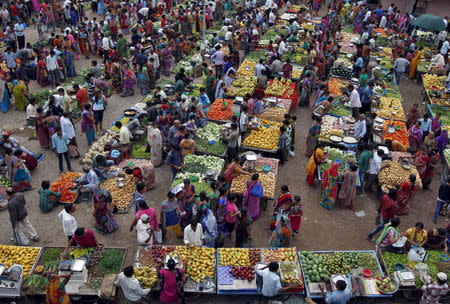 People shop at an open air vegetable and fruit market in Ahmedabad, June 12, 2015. REUTERS/Amit Dave/Files