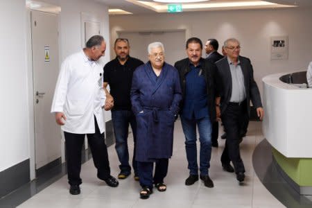 Palestinian President Mahmoud Abbas walks inside the hospital in Ramallah, in the occupied West Bank May 21, 2018. Palestinian President Office (PPO)/Handout via REUTERS