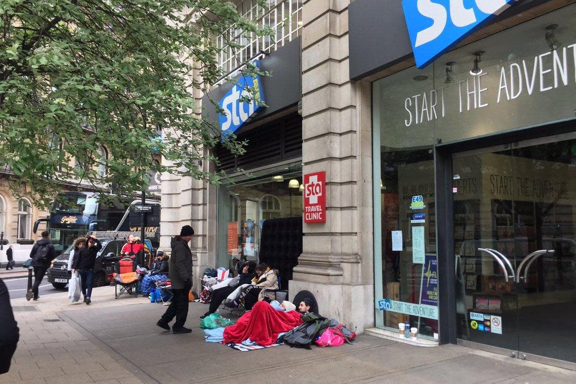 Campers: Hopeful travellers wrapped up outside the shop in Victoria as temperatures drop: Natasha Salmon