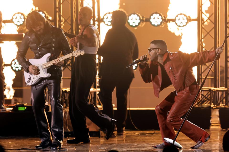 Juanes, left, and Rauw Alejandro perform onstage.