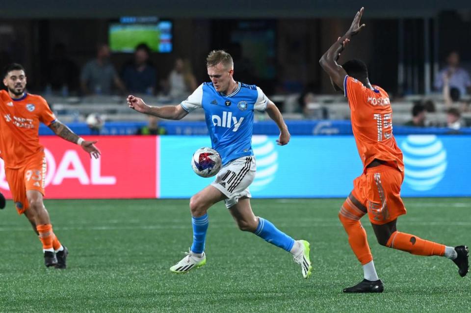 Charlotte FC attacker Karol Swiderski collects the ball as FC Cincinnati defender Yerson Mosquera calls for a hand ball in the second half at Bank of America Stadium on Jul 8, 2023.